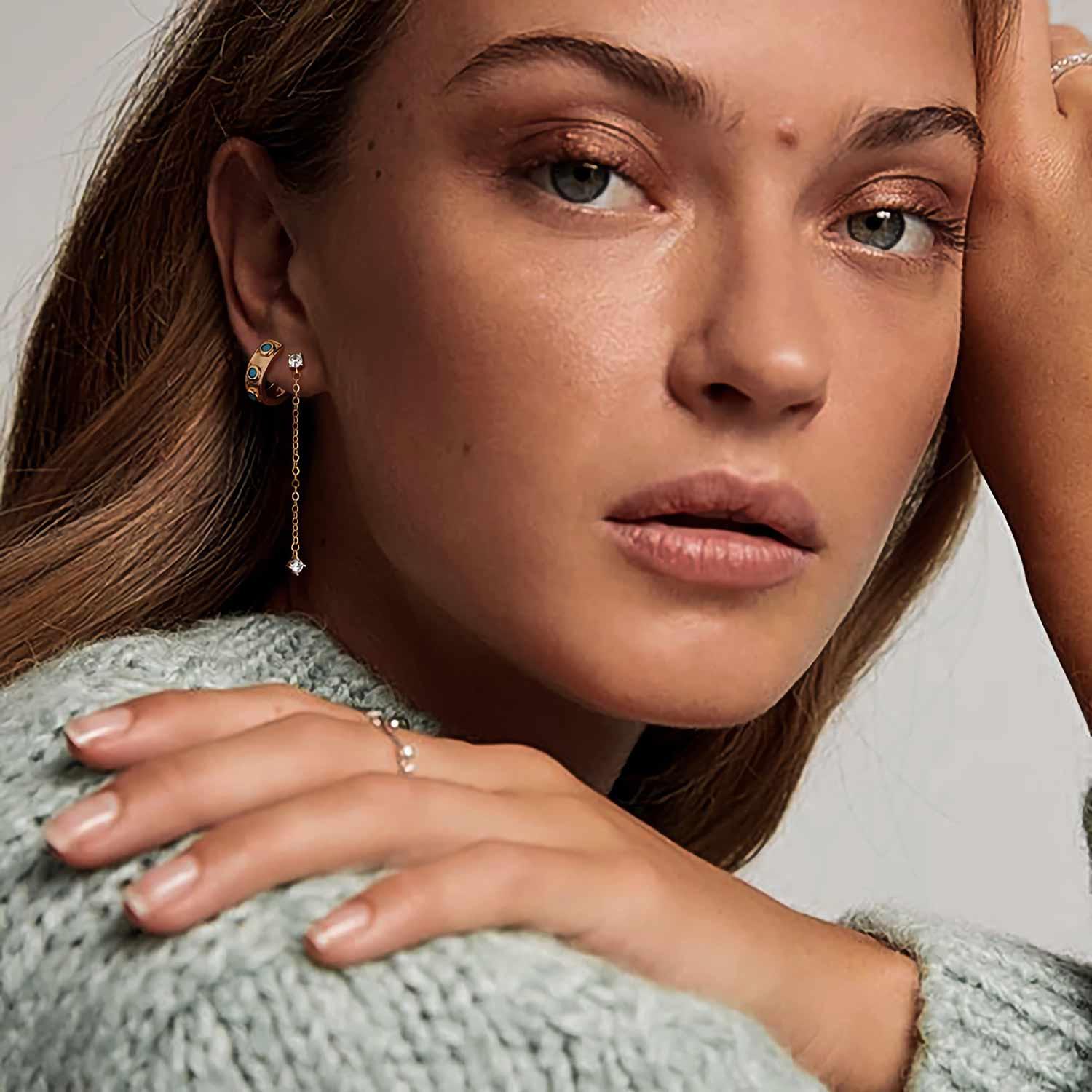 Close-up of model wearing MYEARS Diamond Dangle Chain stud earrings in gold, stylish earrings for women