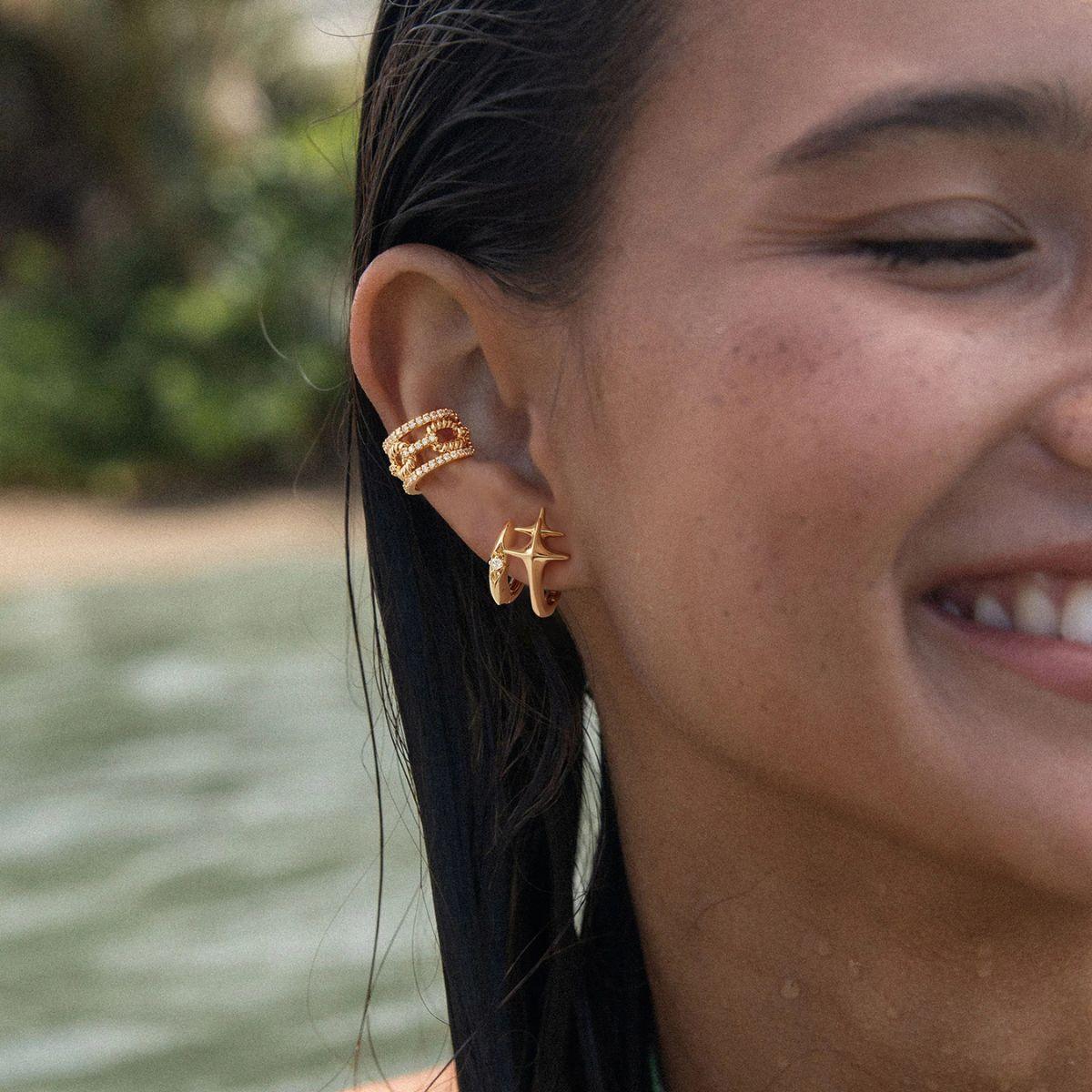 Lifestyle shot of MYEARS® Double Cross Star Hoop Earrings in gold, styled for women’s everyday wear and modern gift occasions
