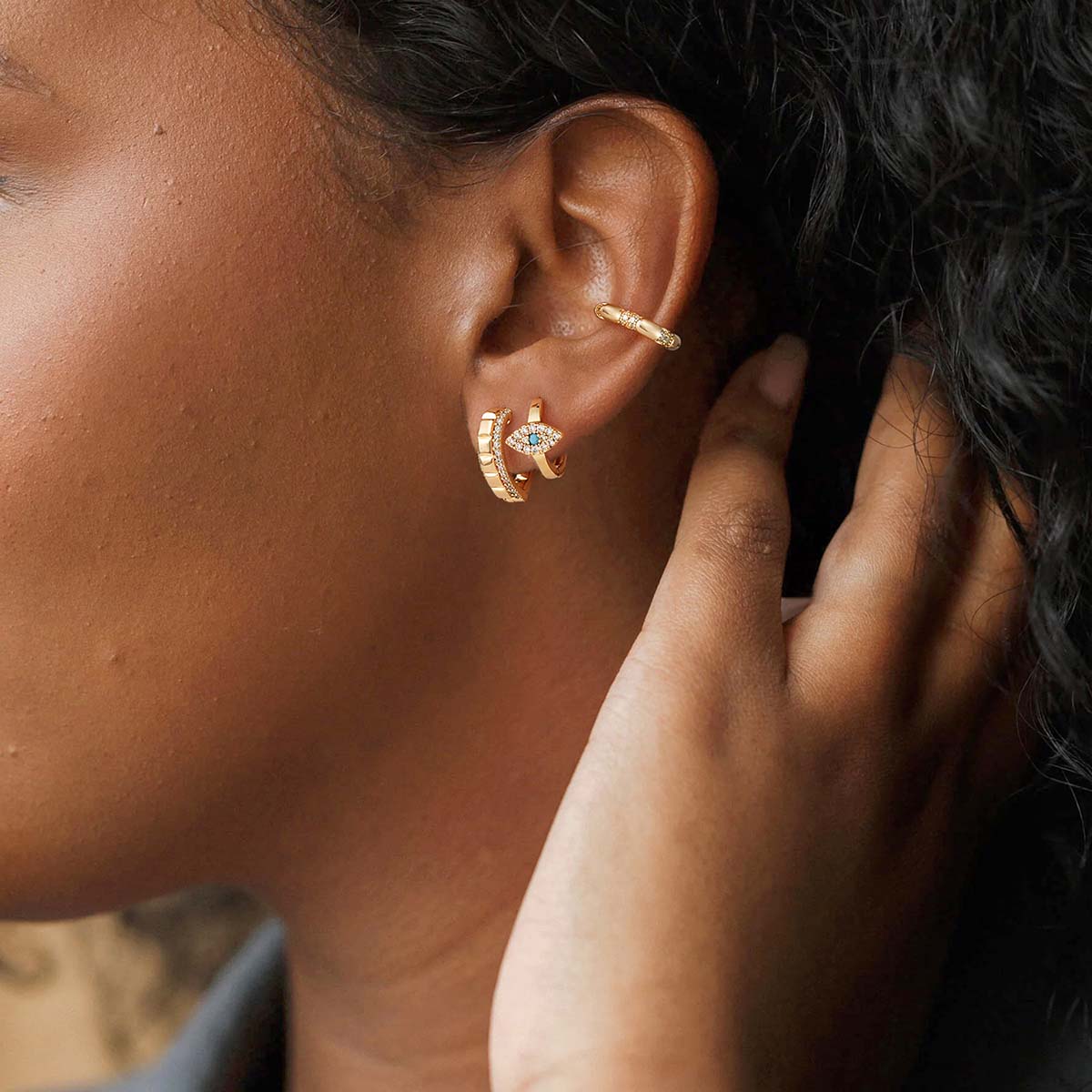 Woman wearing MYEARS® Evil Eye Hoop Earrings in gold, elegant hoops perfect for everyday wear and gifting