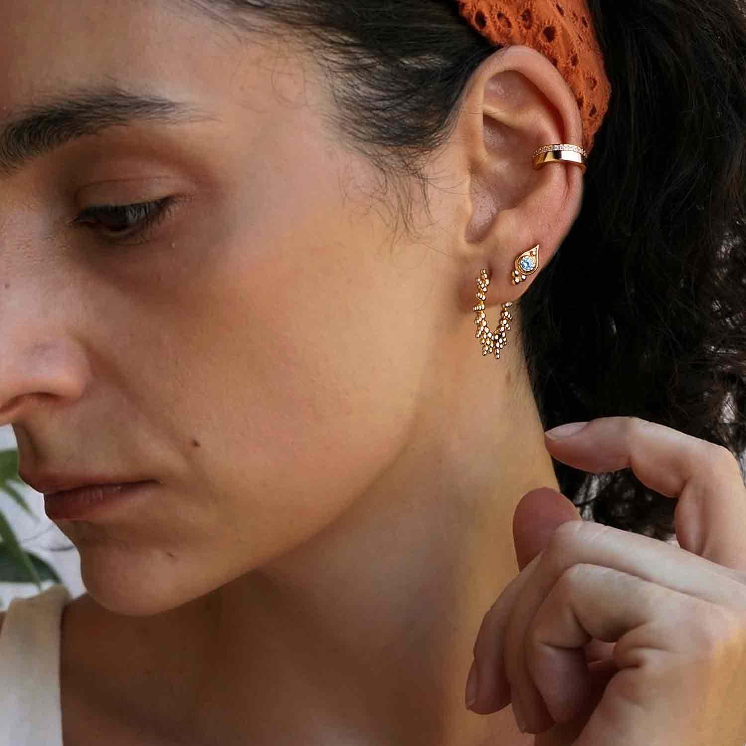 Close-up of MYEARS® Gold Sunburst Beaded Huggie Hoop Earrings worn by model, delicate beaded hoop design