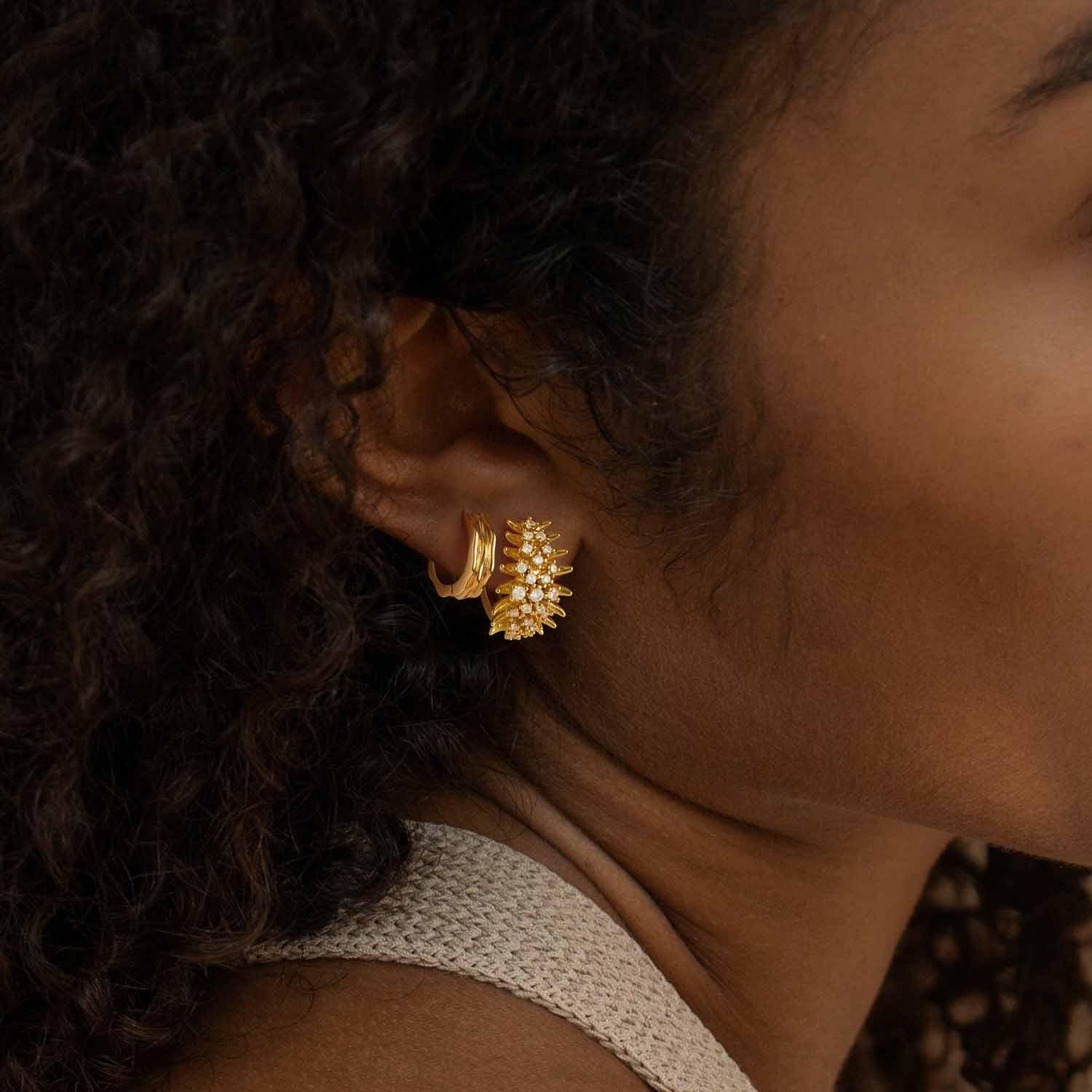 Close-up of MYEARS® Gold Triple Ribbed Hoop Earrings worn by model, textured ribbed hoop design