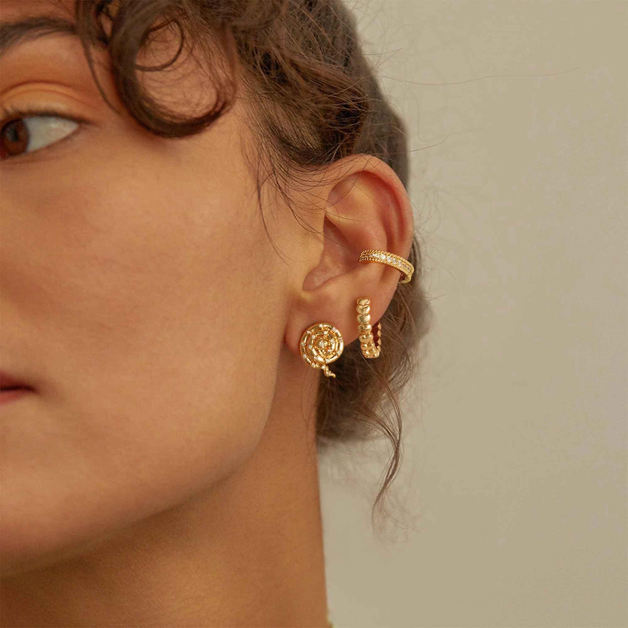 Woman wearing MYEARS® Heart Stack Huggie Hoop Earrings in gold, stylish and versatile for daily outfits