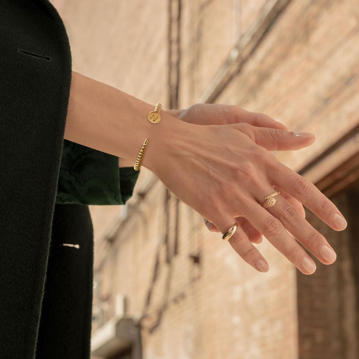 Model wearing MYEARS® gold initial open cuff bracelet, elegant everyday jewelry for women