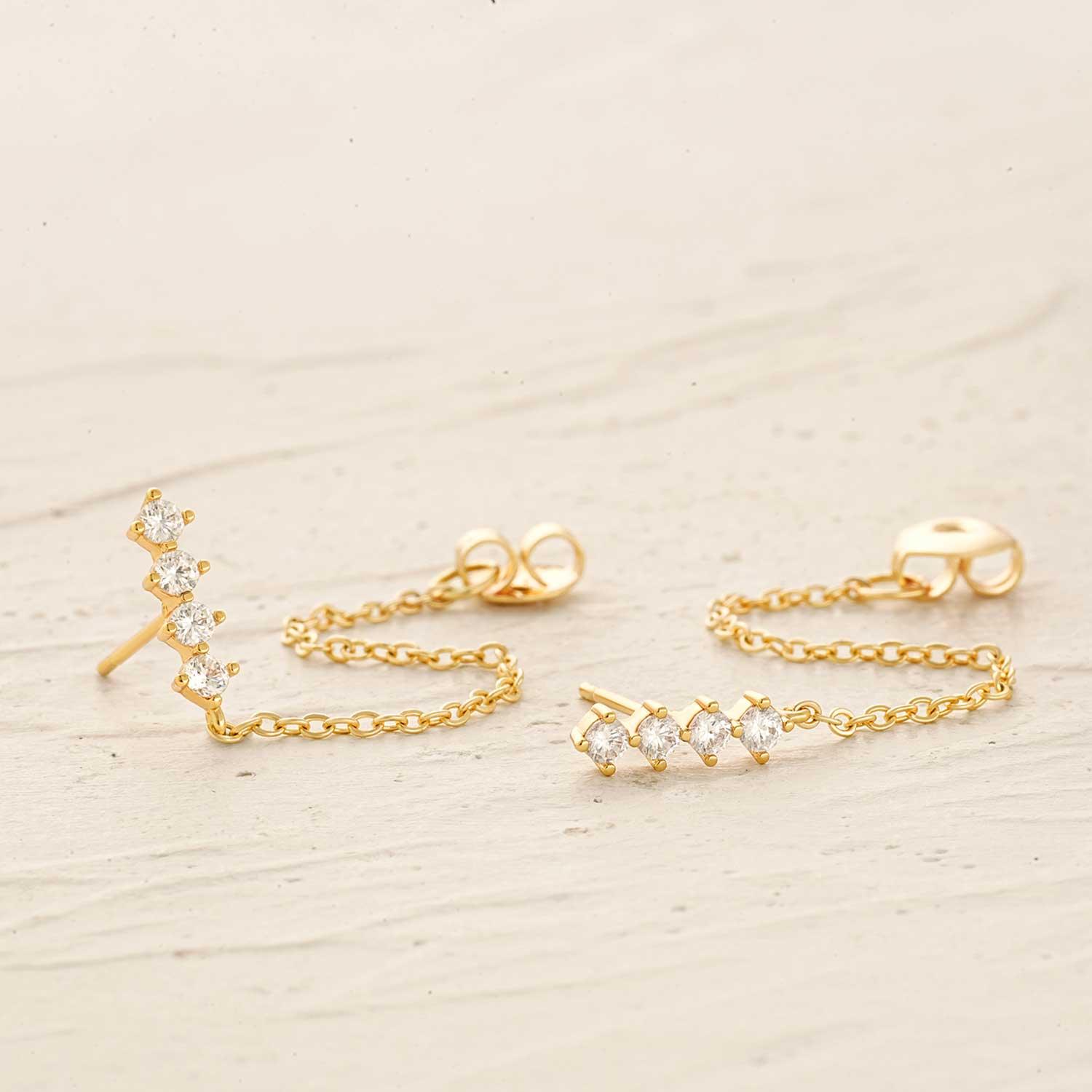 Detailed close-up of MYEARS Quartet Chain Drop stud earrings, showcasing gold finish and unique chain design