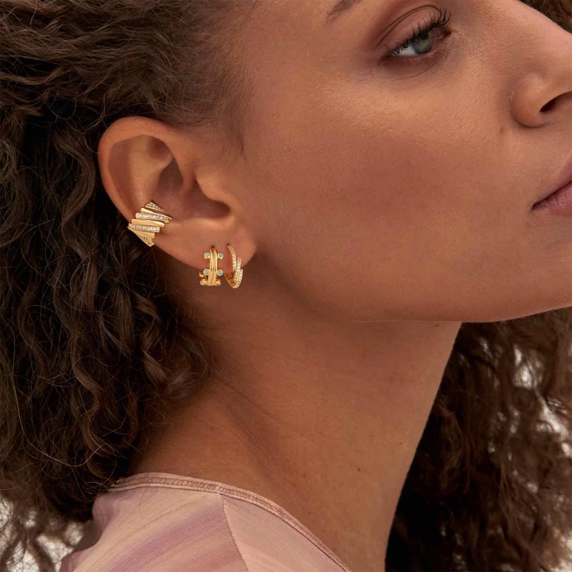 Lifestyle image of MYEARS® turquoise hoop earrings in gold, styled for women’s everyday wear and thoughtful gift occasions