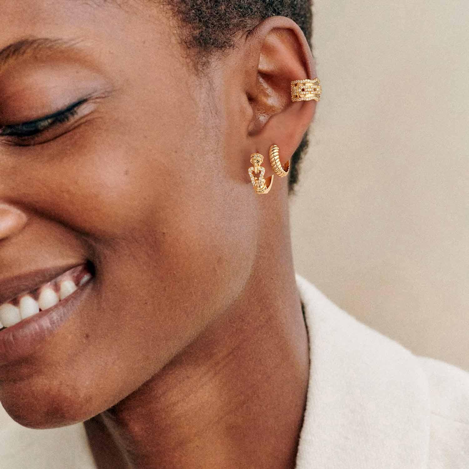 Close-up of MYEARS® Twisted Hoop Earrings worn by a woman, showing elegant gold twisted design