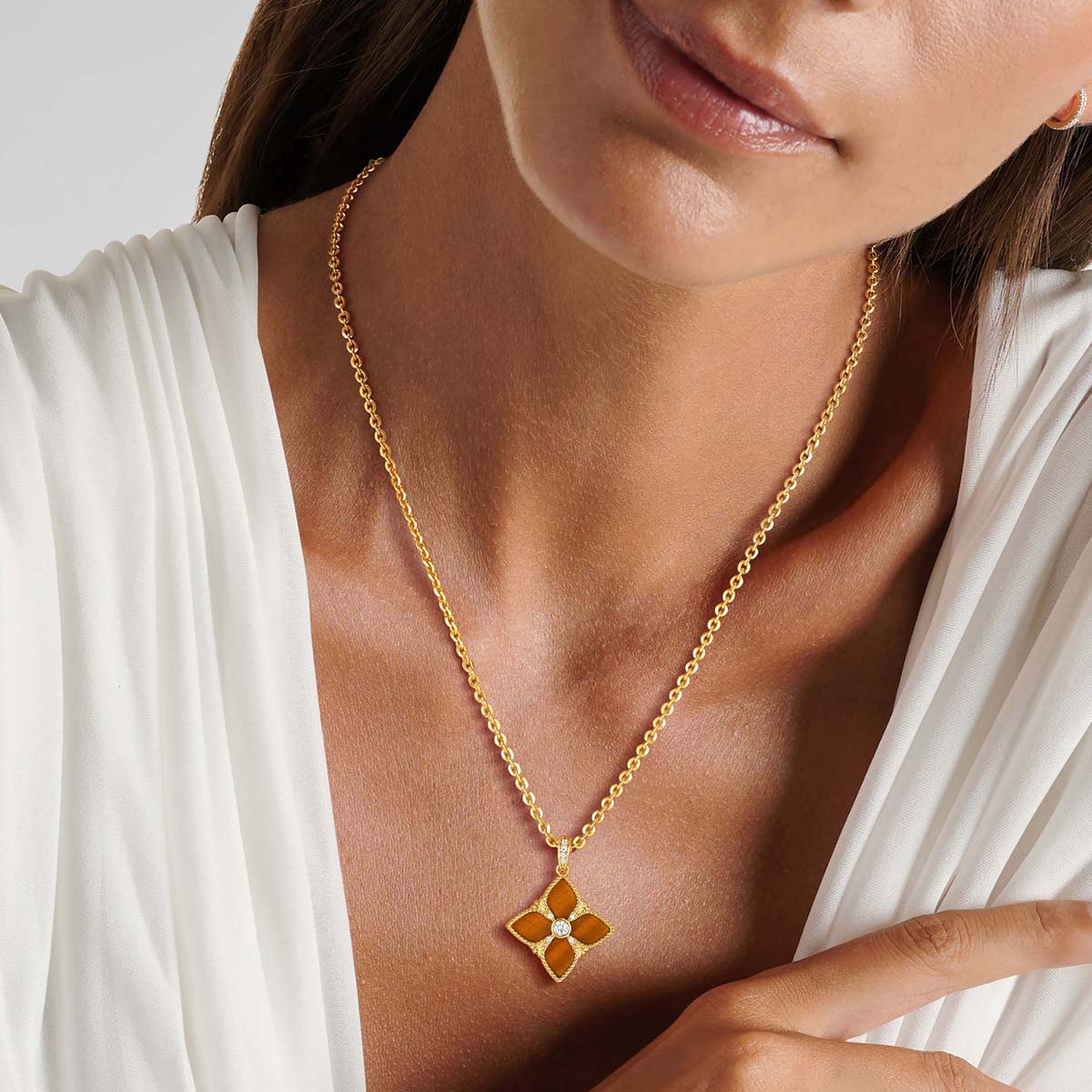 Model wearing MYEARS Yellow Tiger Eye 4 Leaf Clover Necklace in gold, elegant and lucky design for women, perfect for everyday wear