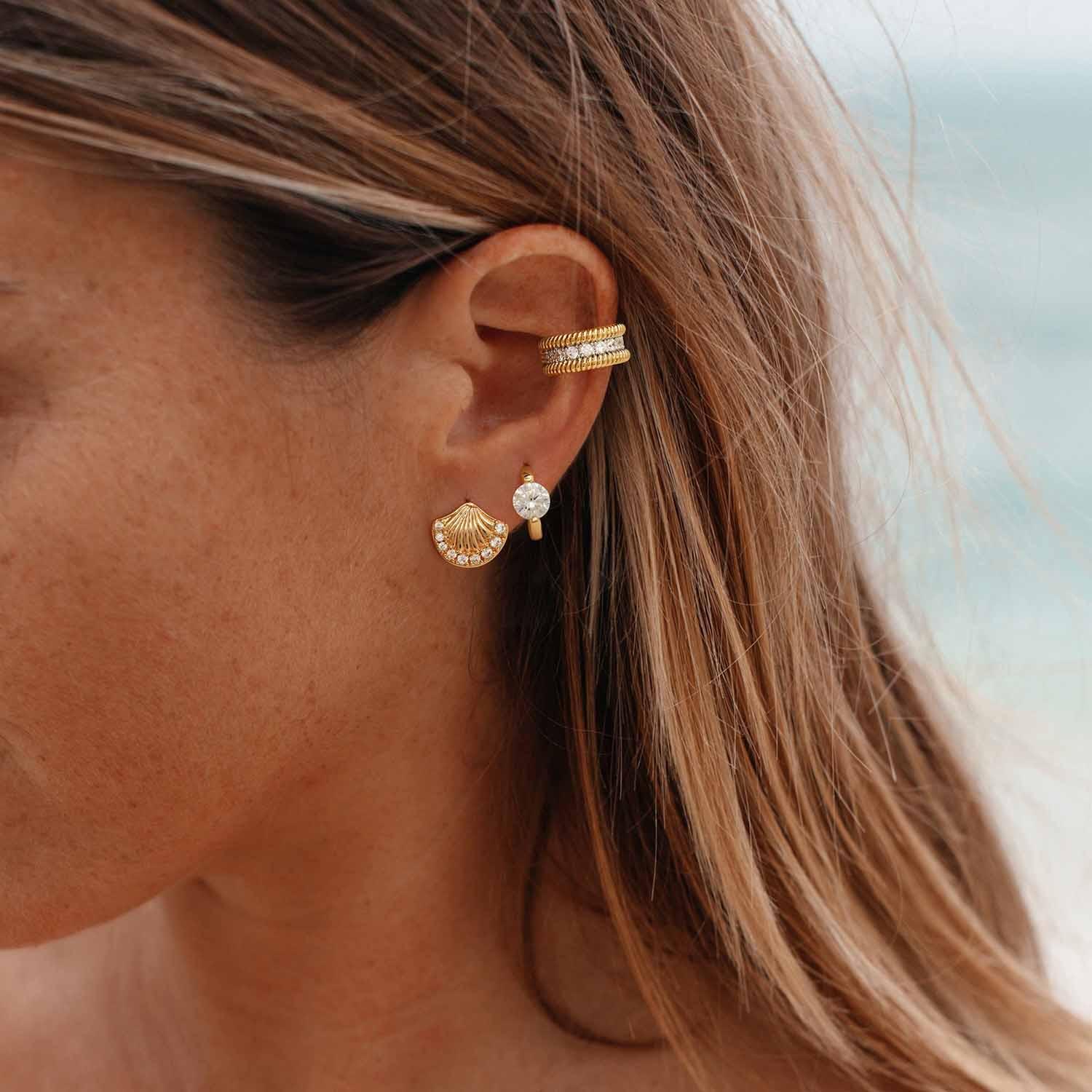 Model wearing MYEARS® shell stud earrings, delicate gold shell earrings styled for everyday wear and summer outfits.