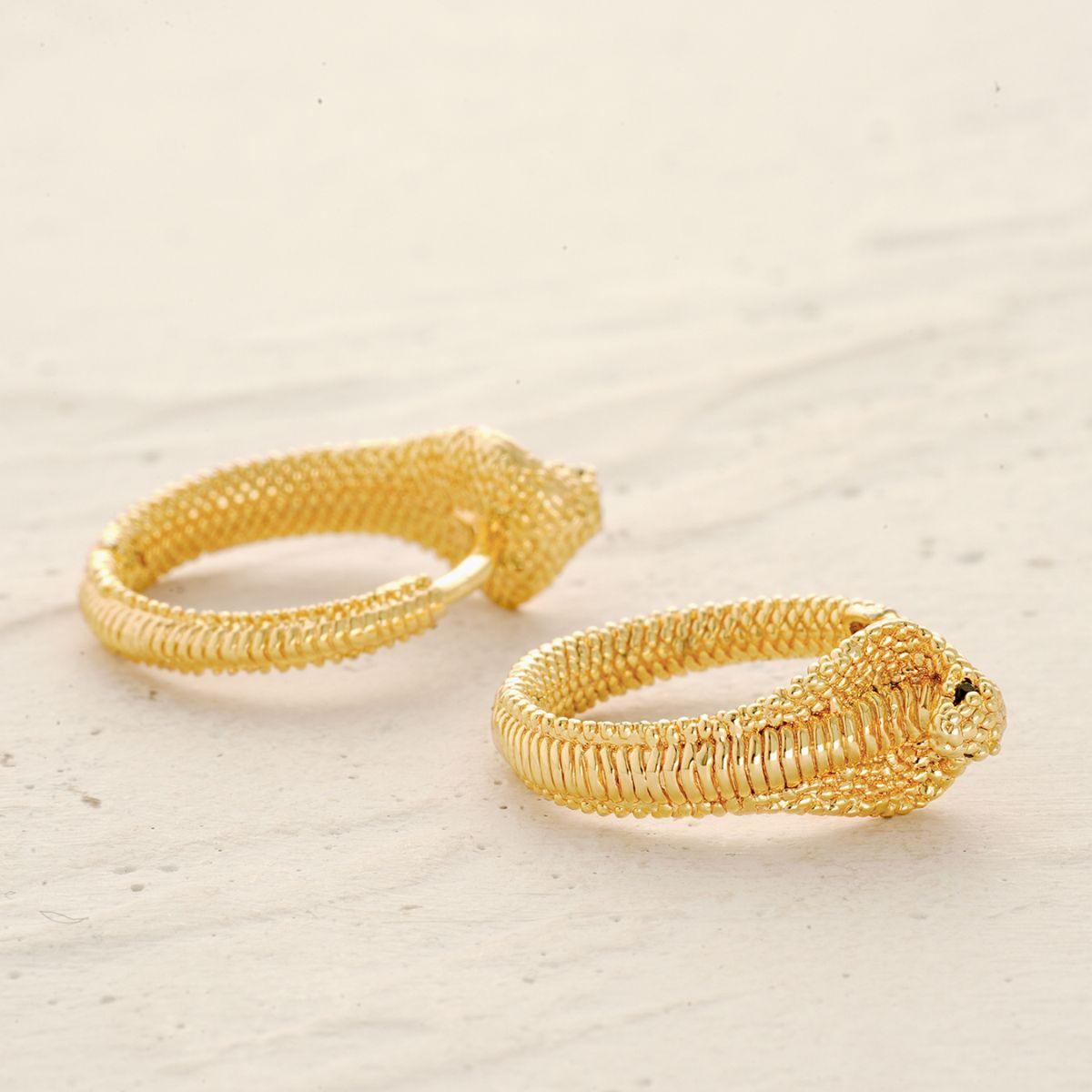 Detail of snake huggie hoop earrings showing sculpted texture and polished finish
