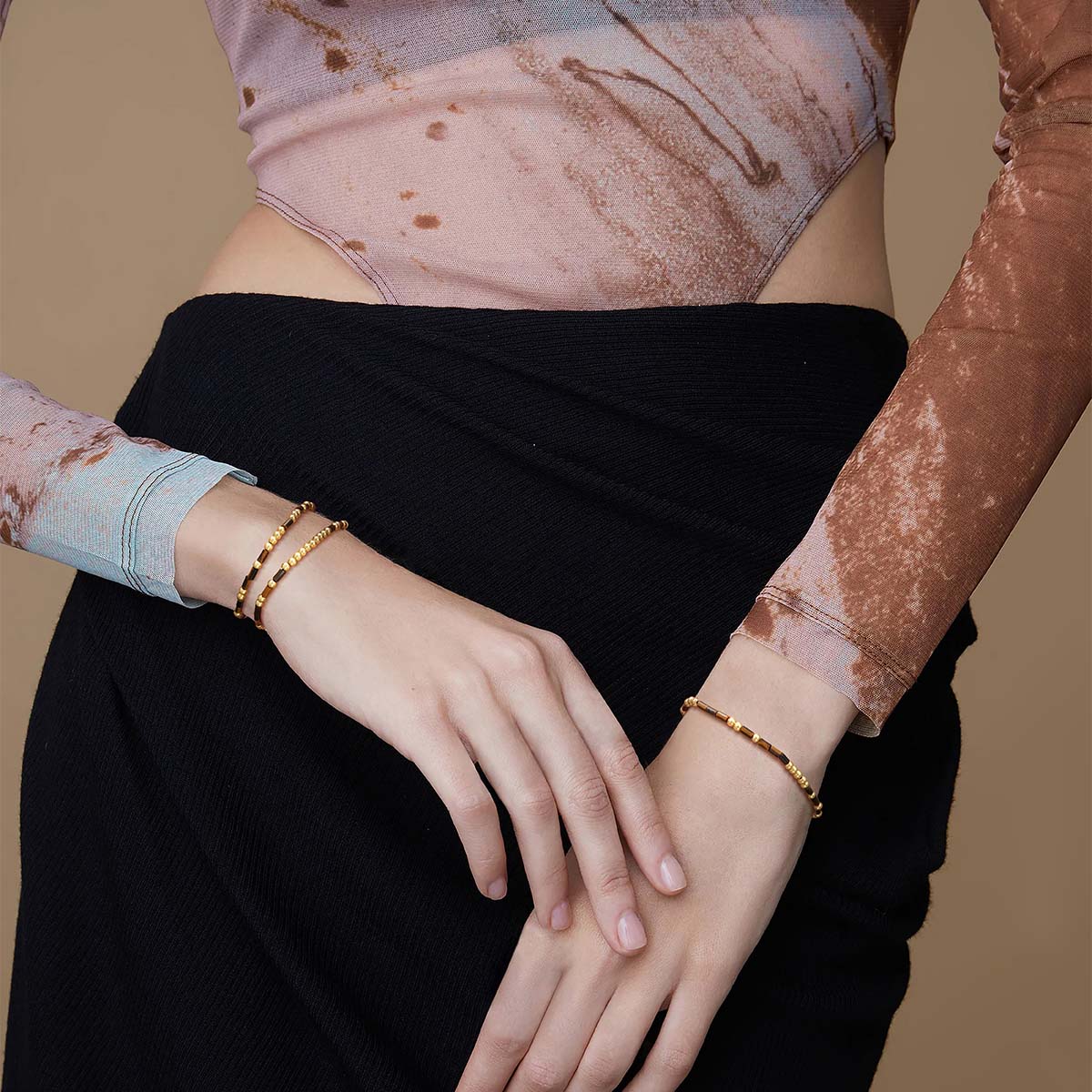 Model wearing the Myears® Tiger Eye Morse Code Bracelet, natural lifestyle look, brown gemstone beaded bracelet for women’s everyday style.