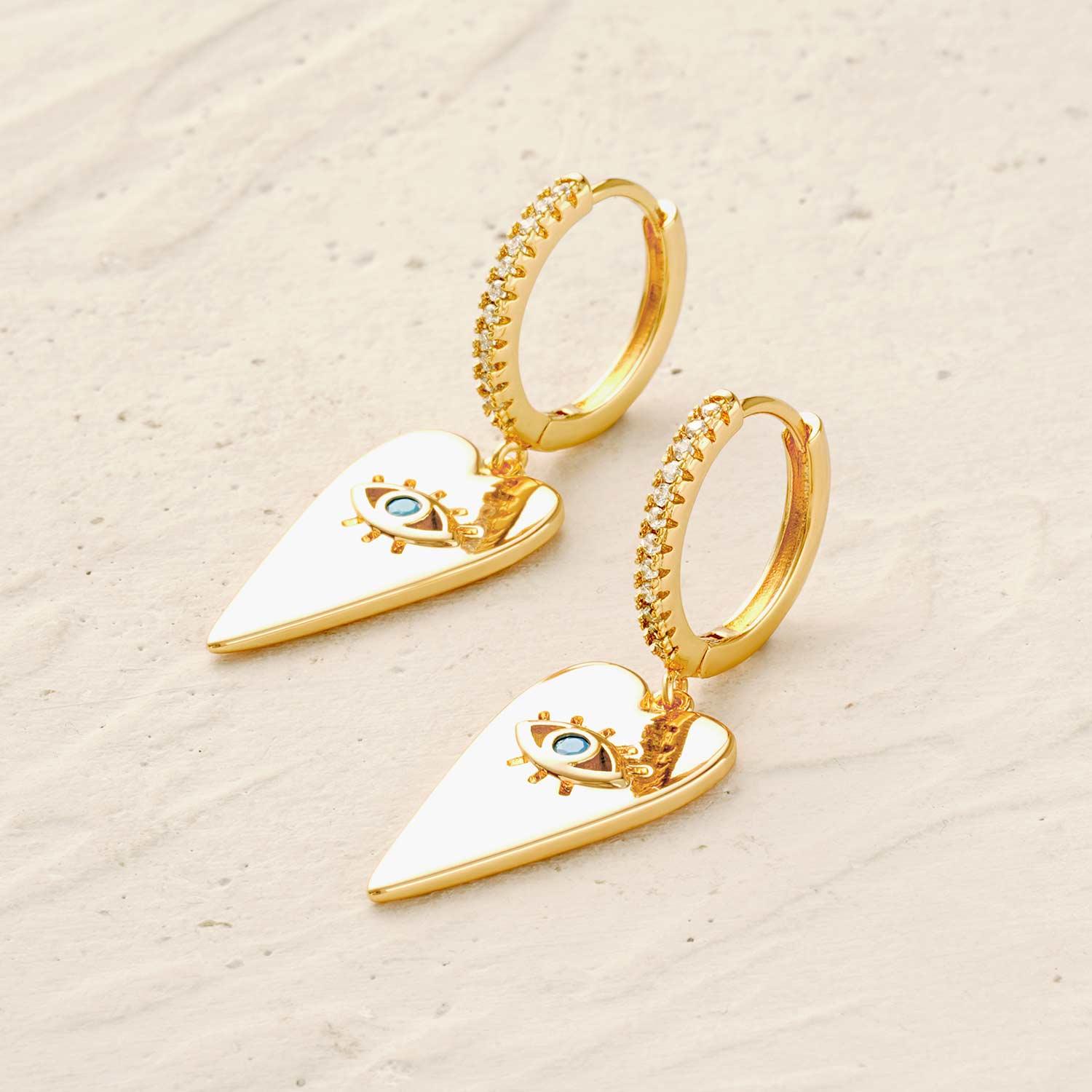 Detail of turquoise evil eye heart drop earrings showing heart shape and turquoise accent