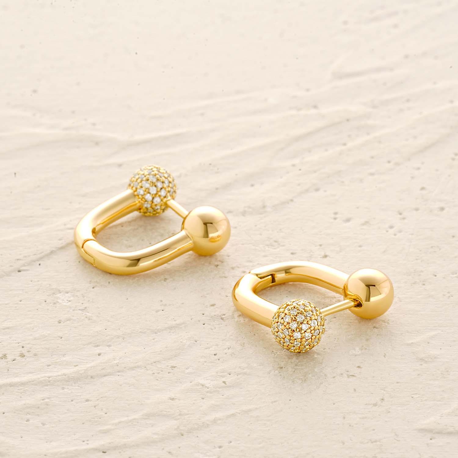Detail of U Shaped Hoop Earrings showing gold finish and sleek design